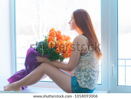 Woman european appearance with bouquet at home in nice mood, girl dreaming about lover
