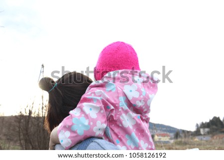 child and young woman walking an abandoned railway line catching the last rays of the sun that day.