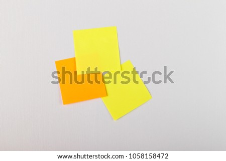Wooden board with five blank colorful sticky notes.