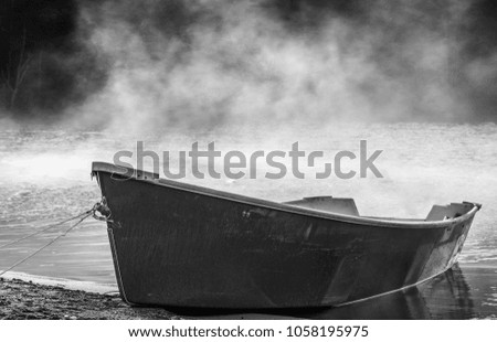 Isolated Boat Floating On The Lake On The Foggy Morning