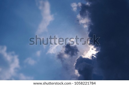 Sunlight behind the clouds and blue sky