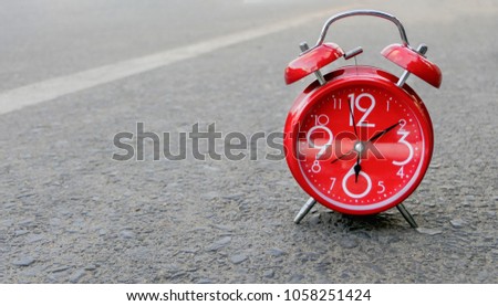 Red alarm clock on the street.