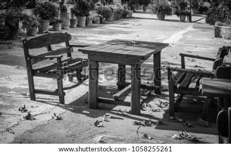 Side view of park bench and table under sunlight, Greece
