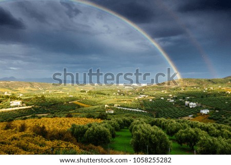 Scenic view of double rainbow and cultivated land, Greece