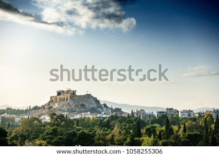 Ancient ruins and residential buildings with lush foliage, Athens, Greece