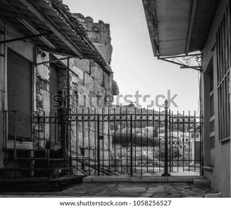 Old ruins with iron gate and mountain landscape, Athens, Greece