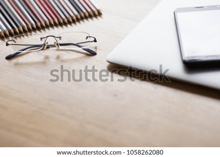 Top view desk work, work place concept.Selective focus eyes glasses on table .