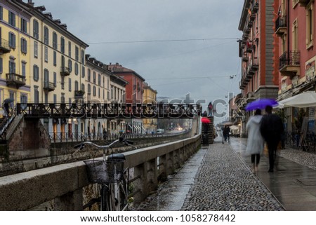 A rainy day on the Naviglio Grande in Milan, Italy Royalty-Free Stock Photo #1058278442
