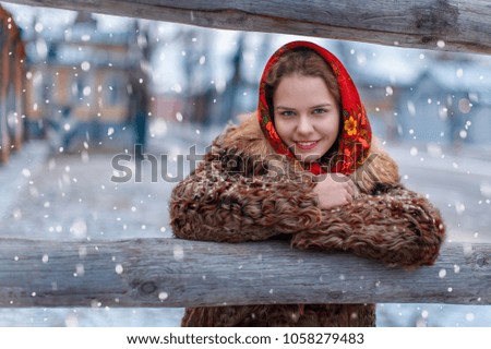 Beautiful young girl in Russian traditional style, winter in the cold. countryside
