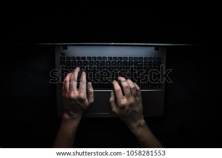 Russian hacker hacking the server in the dark Royalty-Free Stock Photo #1058281553