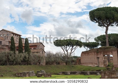 Horizontal picture of ruins and vegetation at Palatine Hill, historical landmark of Rome, Italy