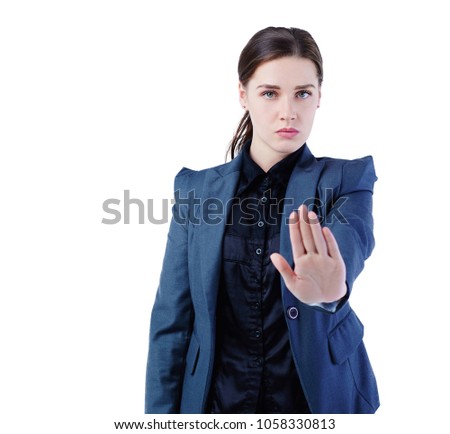 Serious Caucasian businesswoman making stop sign on white background, focus on business woman.