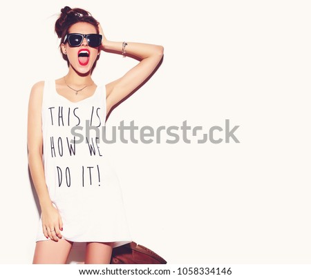 Portrait of young happy woman model with bright makeup and colorful lips in hipster summer clothes isolated on white. Going crazy Royalty-Free Stock Photo #1058334146