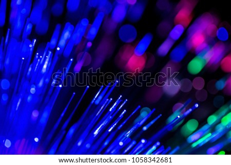 Fiber optics strands light on dark background