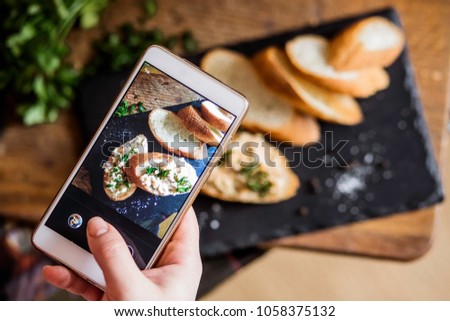 Bread on the board is photographed on the phone