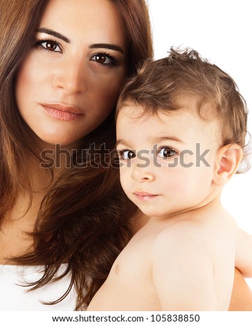 Beautiful mother holding baby boy, mom carry cute child adorable small son, happy family picture, mom and kid modeling indoor, healthy toddler and mommy,  brunette Arabic models, happiness concept