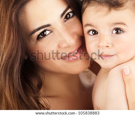 Mother and baby closeup portrait, happy faces, Arabic family picture, adorable small boy, mom and kid having fun indoor, parents joy, holding little child, healthy toddler and mommy, happiness concept
