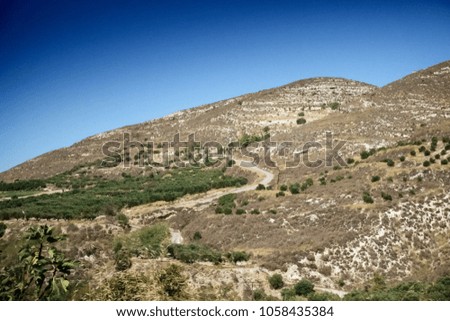 Agricultural field and mountain against sky, Crete, Greece
