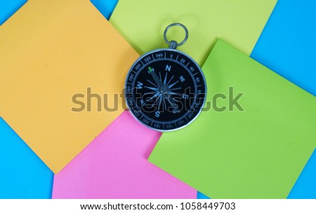 Compass with colorful note paper.   