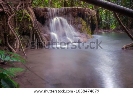 Arawan waterfall in tropical forest Thailand,leaf moving low speed shutter blur,Waterfall in forest of kanchanaburi,Deep forest Waterfall in Kanchanaburi, Thailand,Motion blur of water