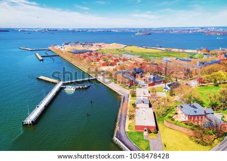 Aerial view from helicopter of Governors Island in Upper New York Bay. New York City, NYC, USA. Liberty Island is on the background