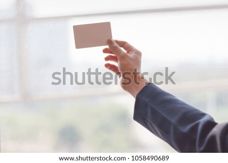 Boss consign empty business card for secretary, Close-up hand holding empty business card, Business card concept,Businessman giving business card of secretary