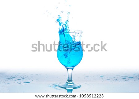 Glass of water with splash against white background