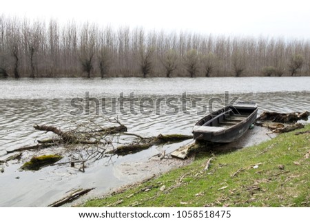 Picturesque Serbia nature - od wooden boat of the fisherman on the banks of the small calm river during a sunny day