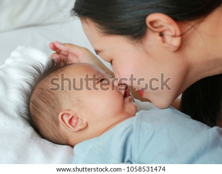 Close up mother nice-smelling newborn baby boy.