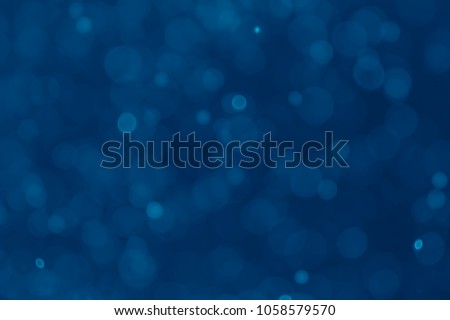 Abstract blue bokeh background. Blurred bright light. Circular points. Colorful. Defocused background.
