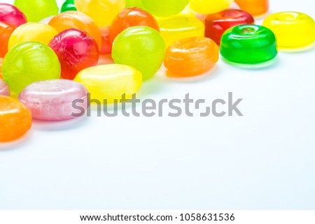 Beautiful colorful and delicious candy sweets and jelly marshmallows. different shapes and composition lollipops and marmalade isolated on abstract blurred white background. Detailed closeup shoot.