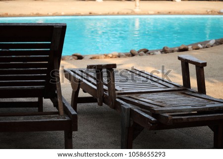 wooden benches beside the swimming pool