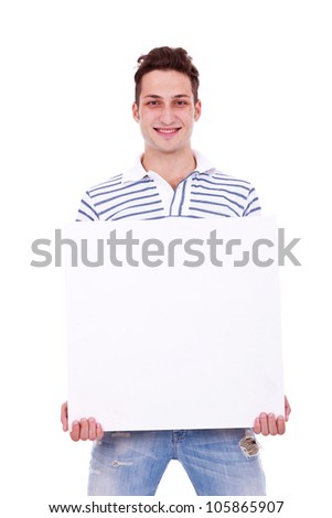 Smiling young casual man holding white sign to write it on your text isolated on white background