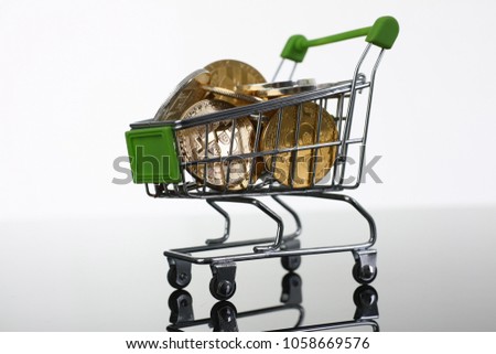 Basket from supermarket with coins crypto currency e bitcoin ethereum litetcoin on a black gray background with reflection exchange purchase sale exchanger closeup.