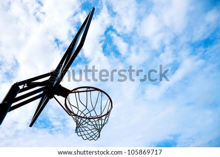 silhouette picture of basketball basket over blue sky