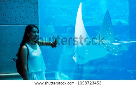 Girl having fun in a large aquarium in Dubai