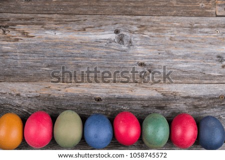 different easter eggs on gray wooden ground