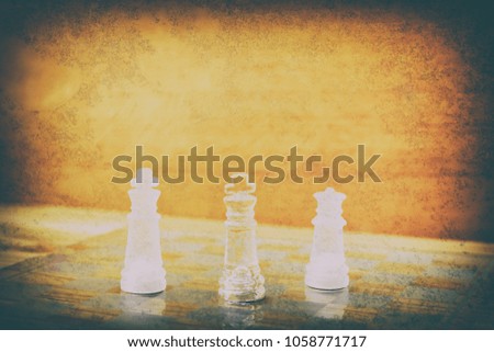 chess glass on board in game. On a vintage wooden floor background vintage scratched old film colors. Concept competition business success. with copy space add text