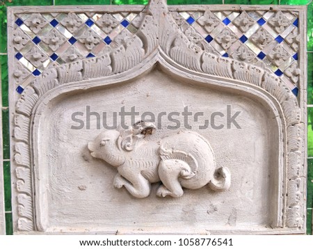 Stucco image convex rabbit pattern surrounded by Thai pattern frame for illustration Thai zodiac concept.