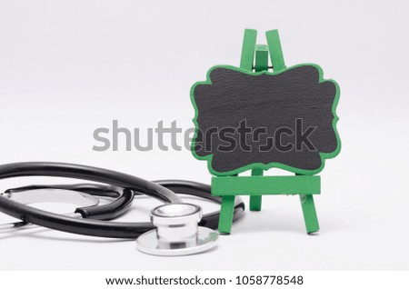 Stethoscope and wooden easel isolated on white background.