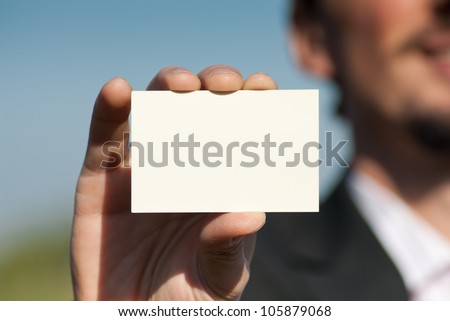 Man holding blank business card