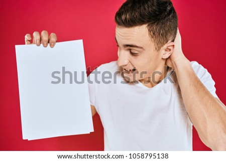  man smiling looking at a sheet of paper, logo, white t-shirt, place free                              