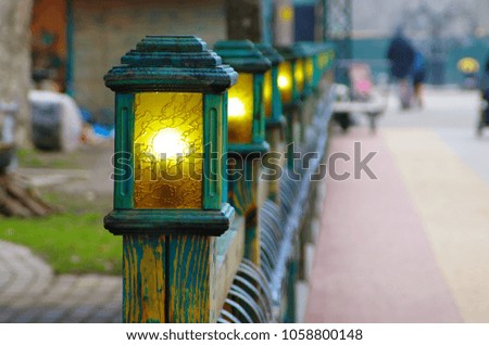 decorative wooden street lamp as an element of the fence