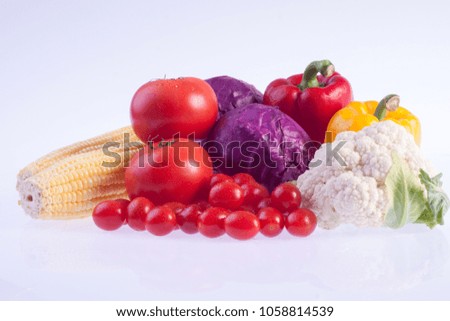 Vegetable in studio, red and yellow paprika , red tomato , fresh , Parsley, Cauliflower,  
Purple cauliflower, 
corn on white background.