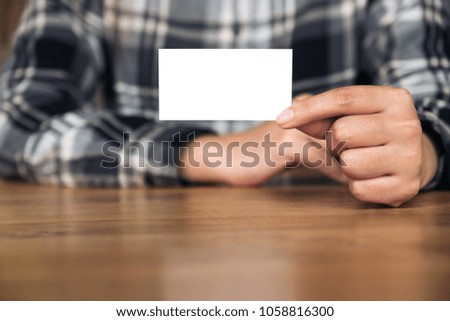 A businesswoman holding and showing an empty business card 