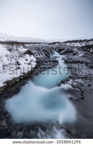 Famous Bruarfoss waterfall with vortex blue water in foreground / Landmark of Iceland