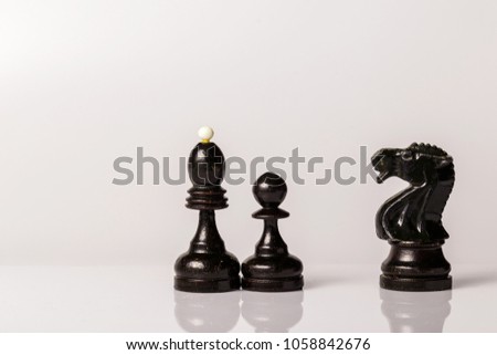 Old vintage chess pieces with cracked paint on a white background closeup