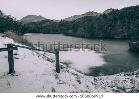 Lake in the mountains during winter with snow