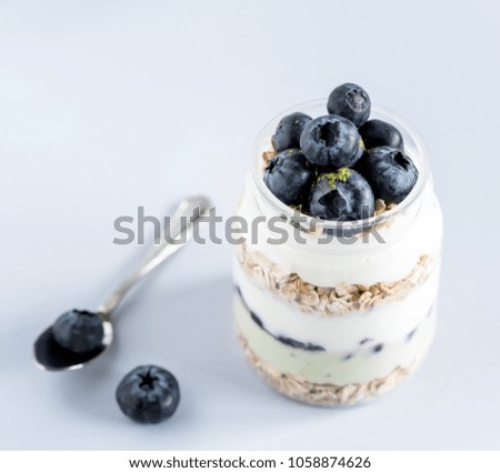 Serving of Yogurt with Whole Fresh Blueberries Oatmeal and Matcha Powder Healthy Diet Food Breakfast Square