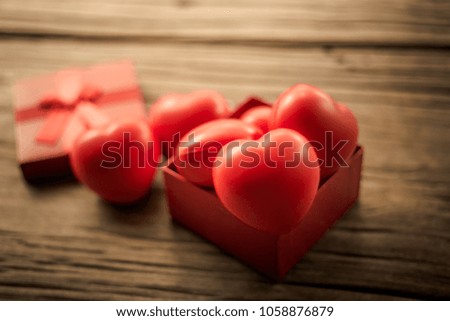 Red heart in  gift box on wooden plank. Concept for valentine day.